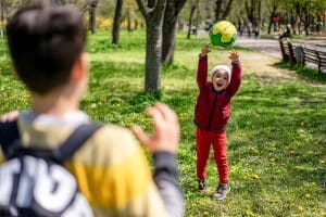 a small child catches a ball